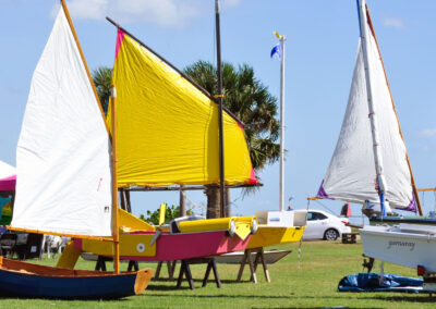 Small sailboats with yellow and white sails