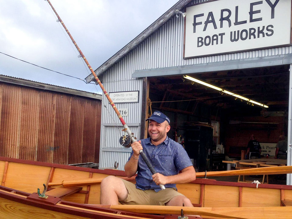 Chet Garner of Daytripper sits in a boat holding a fishing rod outside Farley Boat Works.