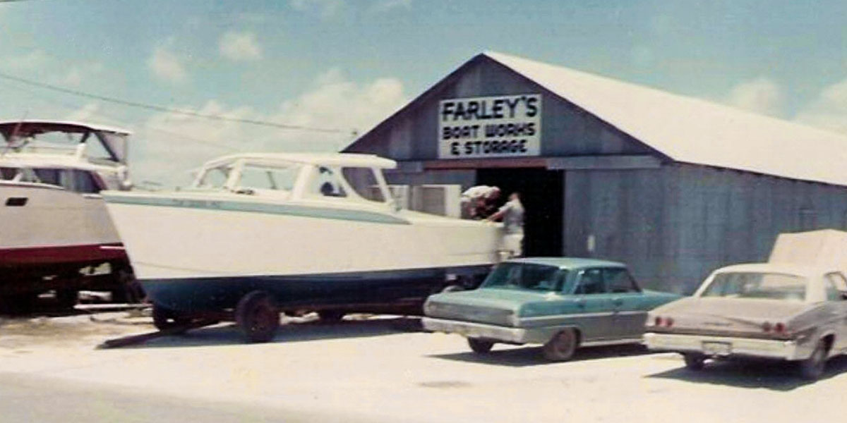 Boats and cars in front of the Avenue C Farley Boats location.