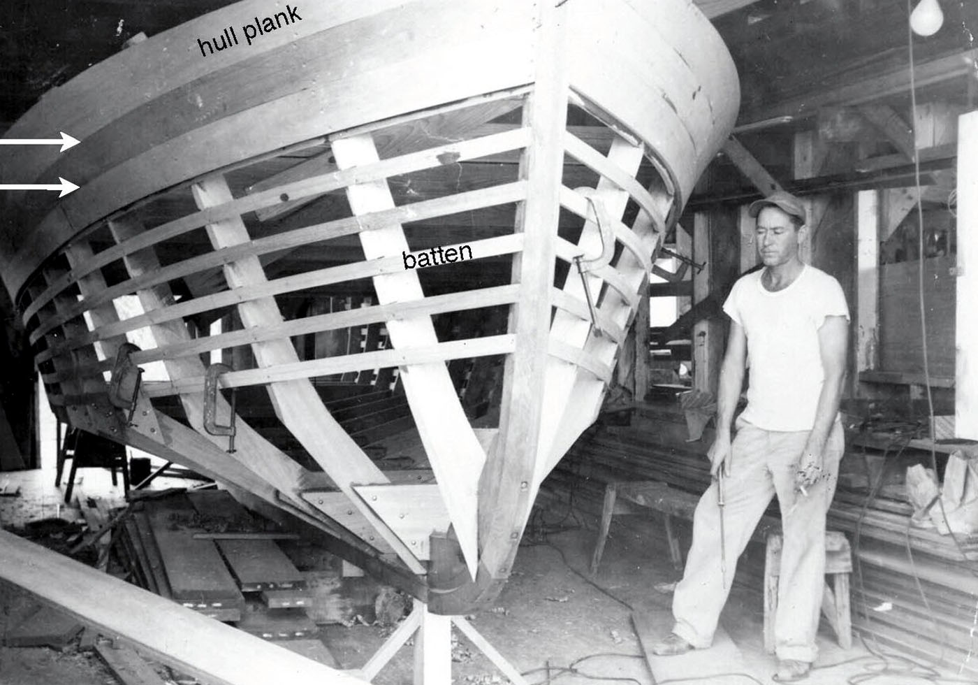 Jim Farley standing next to a boat hull.