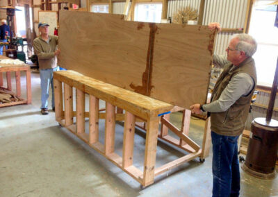Markand Shroeder (left) and Harold Yoesel (right) hold the roughed out centerboard.
