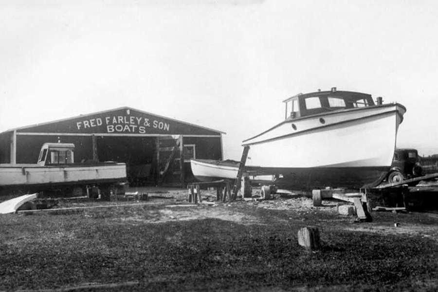 Boat in front of the Farley Boat Works building