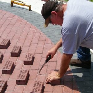 Man laying brick pavers