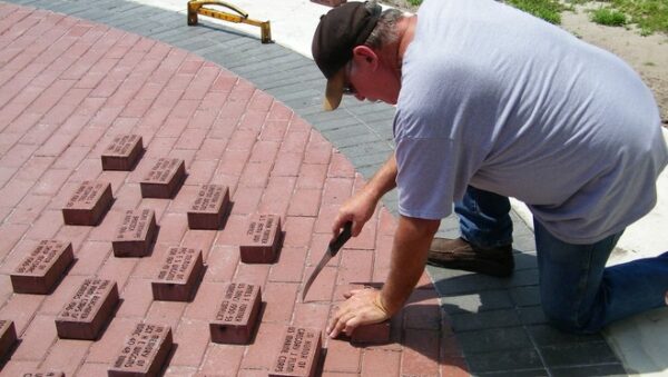 Man laying brick pavers
