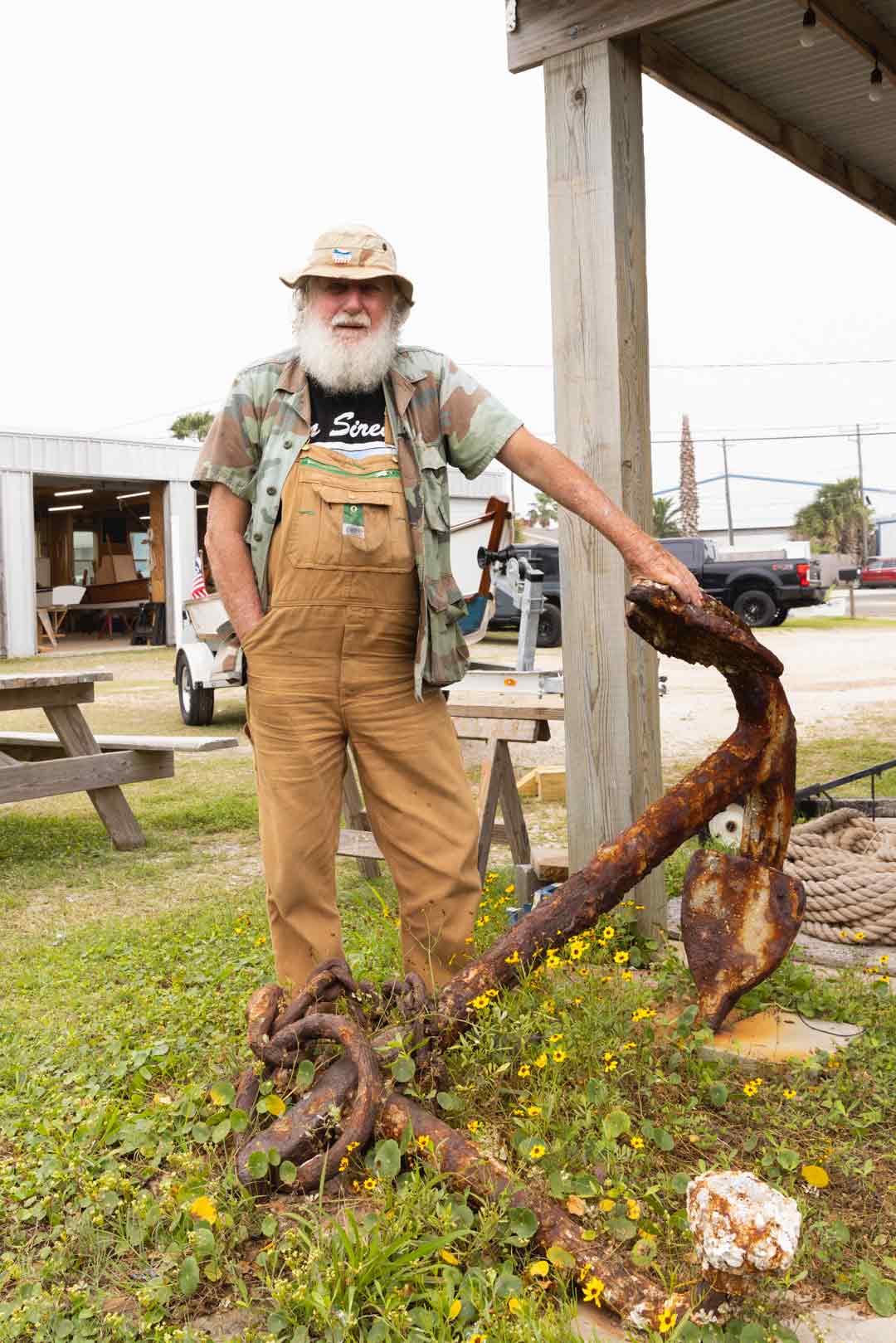 Charles Ferguson next to a rusted anchor