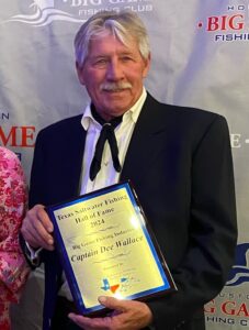 Dee Wallace holding a placque from the Saltwater Fishing Hall of Fame